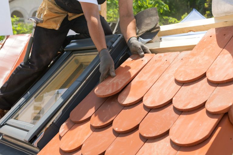 Hands,Of,Roofer,Laying,Tile,On,The,Roof