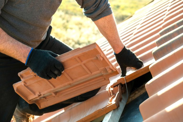 Closeup,Of,Worker,Hands,Installing,Yellow,Ceramic,Roofing,Tiles,Mounted
